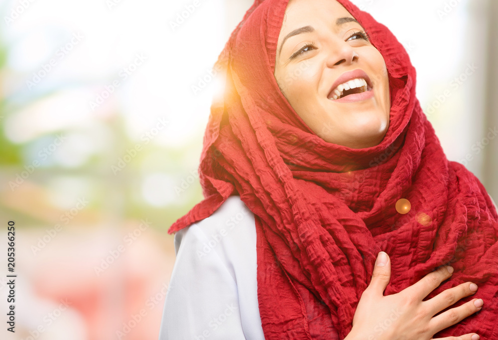 Young arab woman wearing hijab confident and happy with a big natural smile laughing Young arab woman wearing hijab confident and happy with a big natural smile laughing