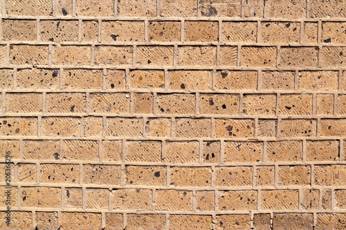 Fotografie, Obraz A brick wall built of bricks of the pink Armenian tuff