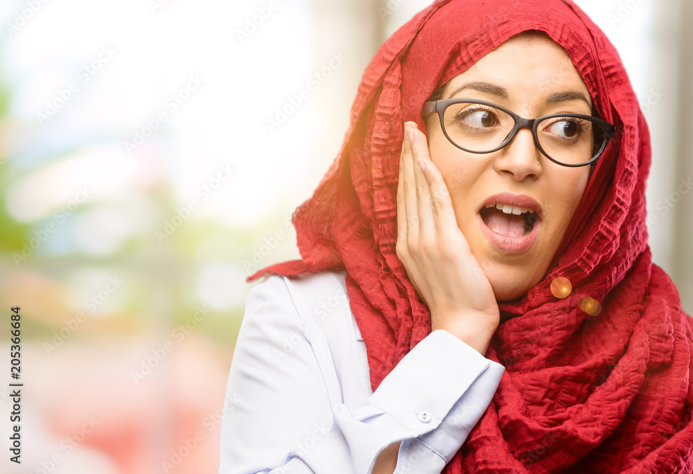 Young arab woman wearing hijab so happy and confident showing a big smile surprised finger Young arab woman wearing hijab so happy and confident showing a big smile surprised finger