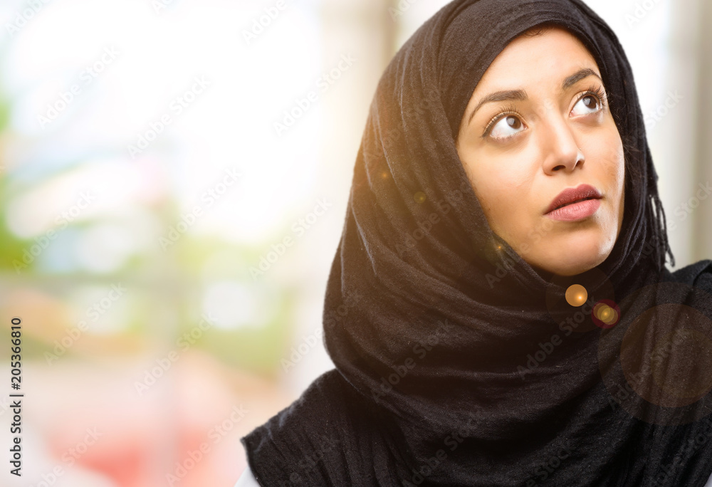 Young arab woman wearing hijab confident and happy with a big natural smile laughing Young arab woman wearing hijab confident and happy with a big natural smile laughing