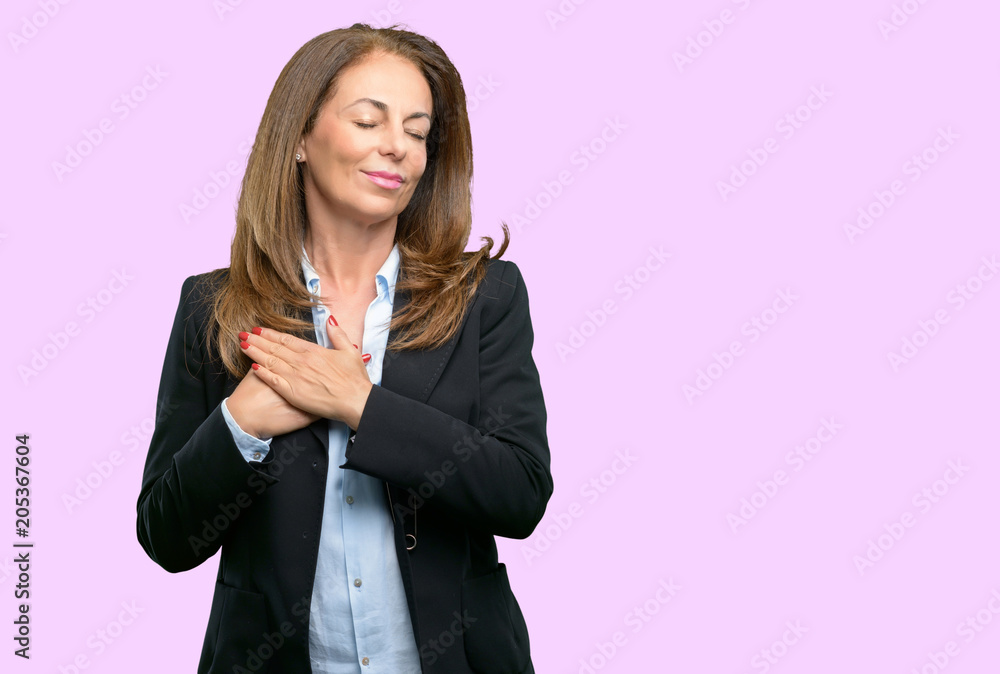 Middle age business woman with hands in heart, expressing love and health concept Middle age business woman with hands in heart, expressing love and health concept