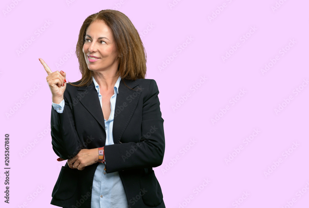 Middle age business woman pointing away side with his finger Middle age business woman pointing away side with his finger