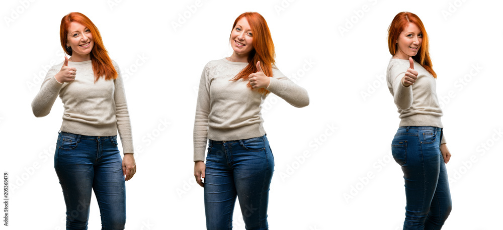 Young Beautiful redhead woman smiling broadly showing thumbs up gesture to camera, expression of like and approval