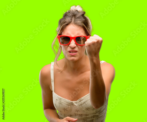 Young beautiful woman wearing red sunglasses irritated and angry expressing negative emotion, annoyed with someone