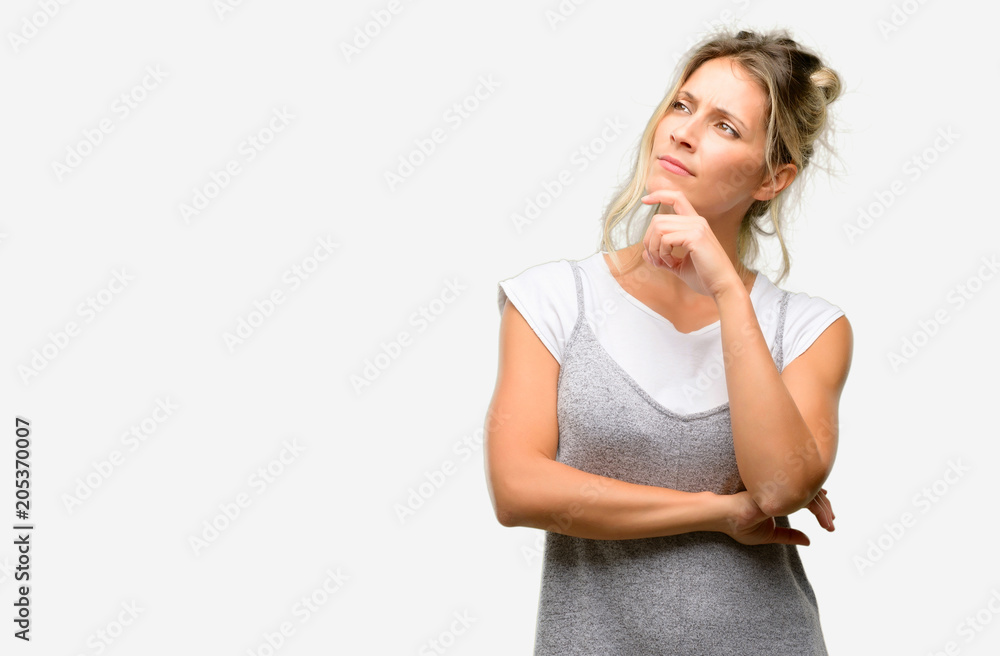 Young beautiful woman thinking and looking up expressing doubt and wonder Young beautiful woman thinking and looking up expressing doubt and wonder