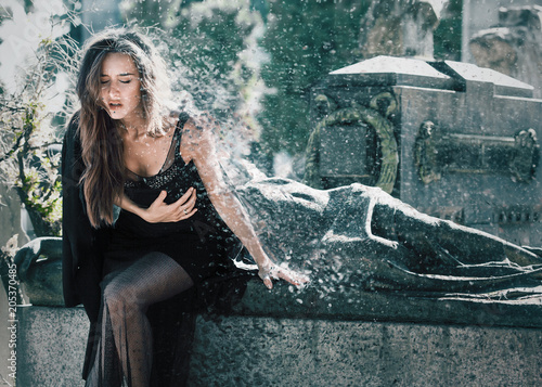 Afflicted woman portrait sitting on a grave - Dispersion effect