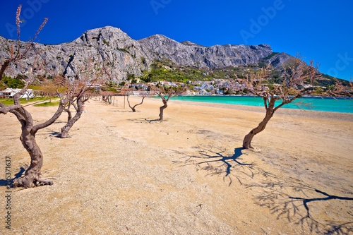 Town of Omis sand beach and Biokovo mountain coastline view photo