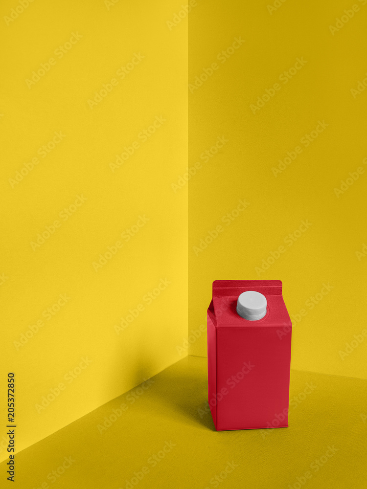 Milk package Pop art Bright pink carton of milk is standing on a yellow ...