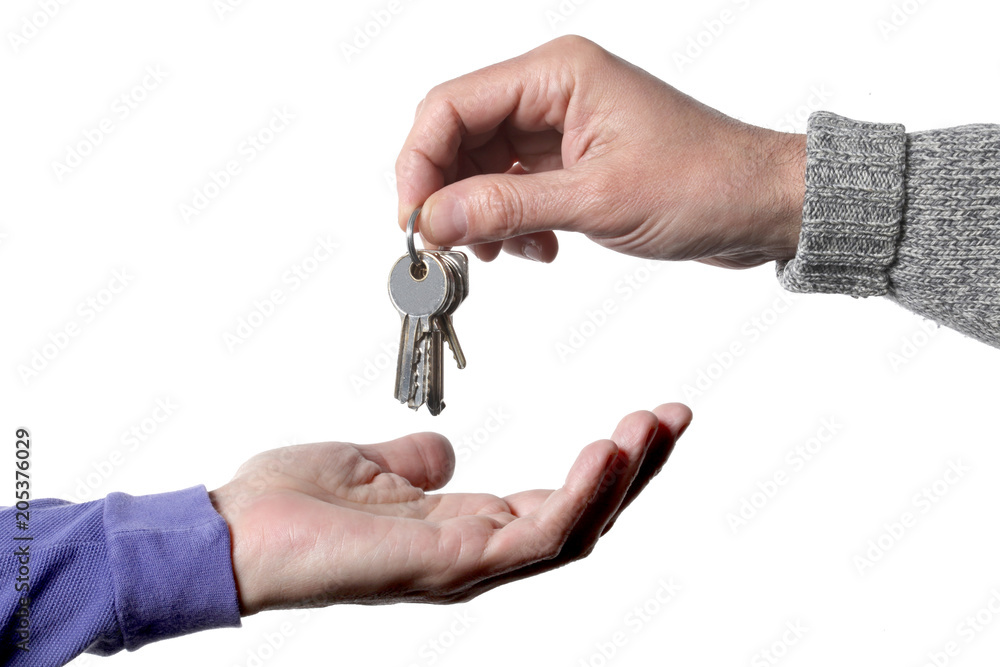 real estate concept: one man's hand giving and one receiving keys door real estate concept: one man's hand giving and one receiving keys door