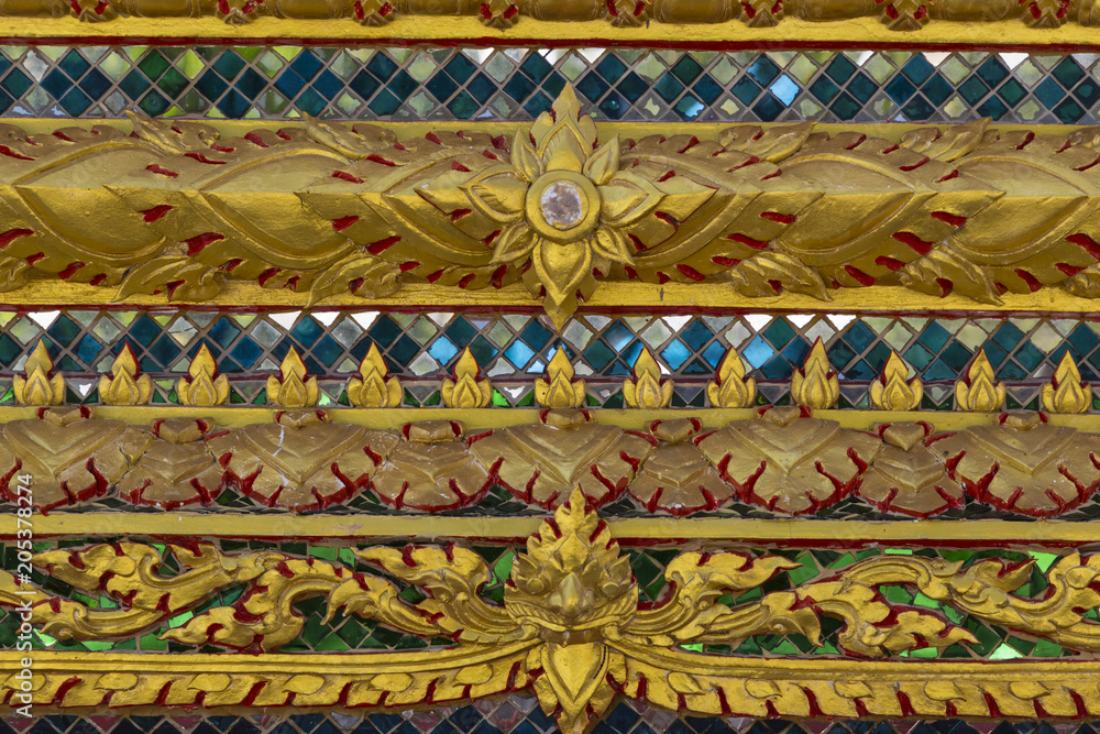 Texture close-up. Beautiful old ornament on the wall of a Thai house Texture close-up. Beautiful old ornament on the wall of a Thai house