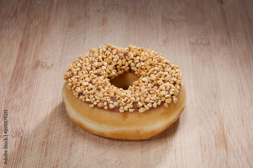 Single delicious donut on wood Single delicious donut on wood