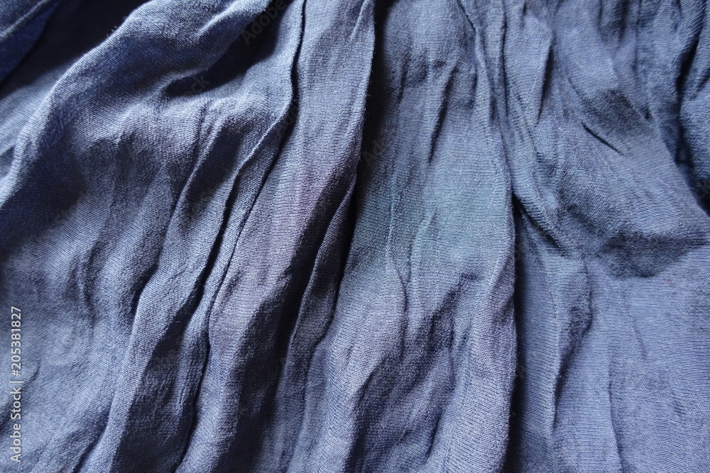 Blue cotton and polyester fabric in soft folds Blue cotton and polyester fabric in soft folds
