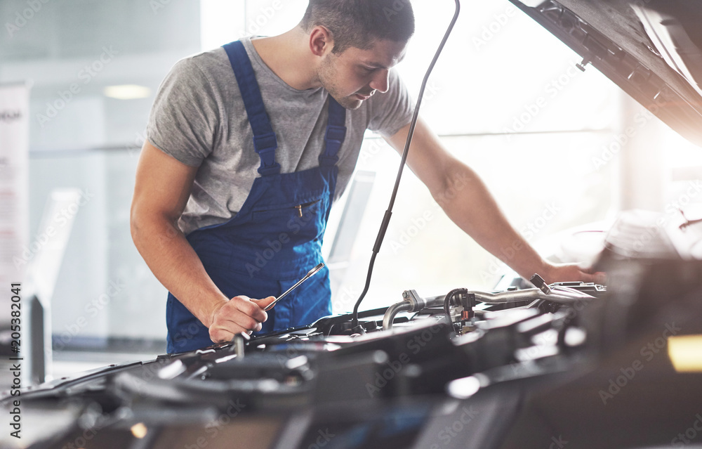 Auto mechanic working in garage. Repair service Auto mechanic working in garage. Repair service