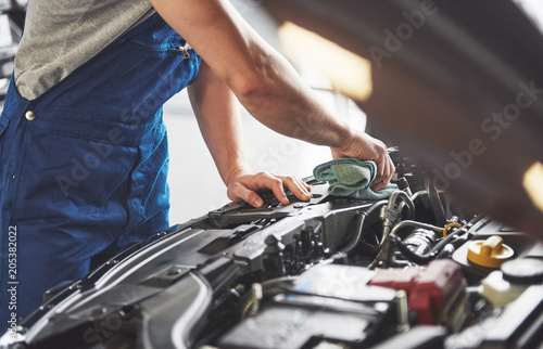 Auto mechanic working in garage. Repair service