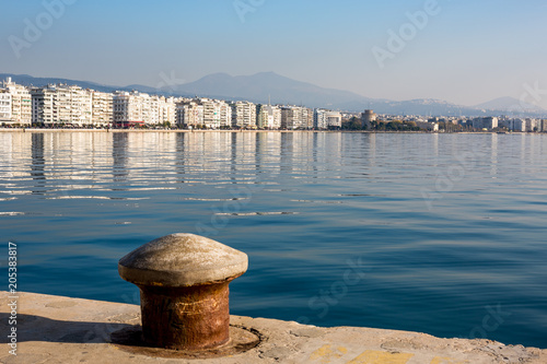 Embankment of Thessaloniki, Greece with reflections in the sea water in a clear sky afternoon