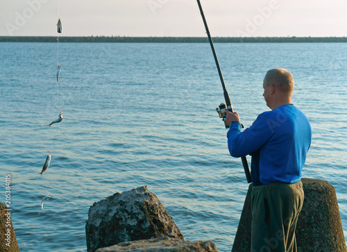 Fishing on a Salak. A man caught a fish on a fishing rod. Fishing in the evening. Sea fishing in the spring.