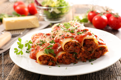 homemade cannelloni with beef and tomato sauce photo