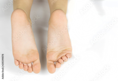 Foot of a little boy on a white background.