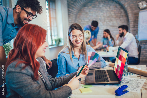 Photography Group of young business people and designer looking at color palette