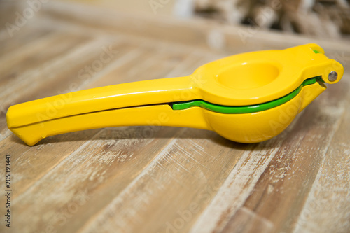 Fotografija Lemon Squeezer  on wooden background.