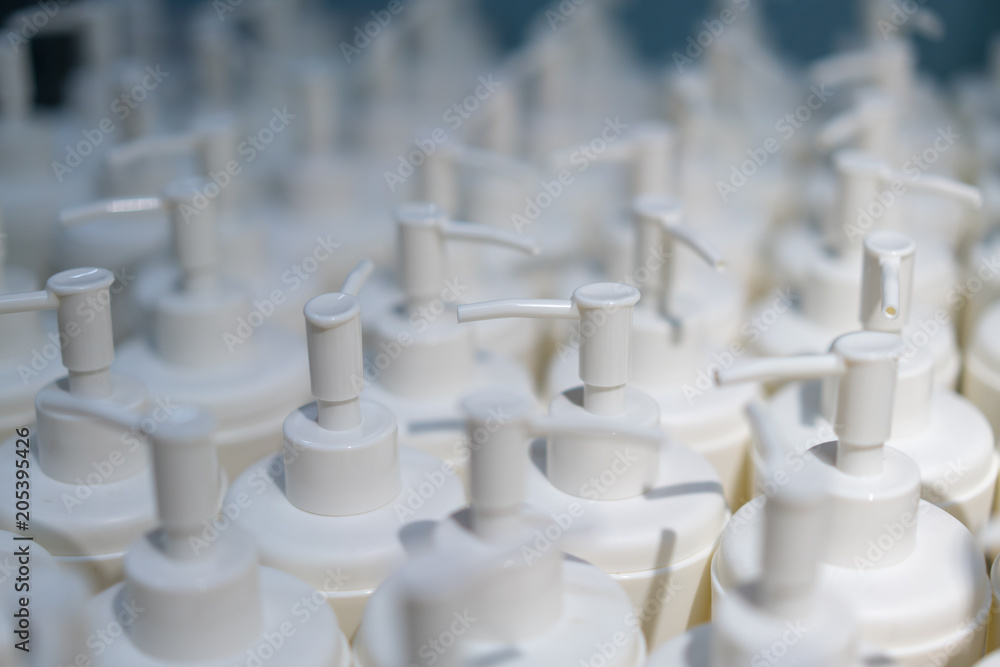 Round white plastic bottle with dispenser pump for liquid soap, shampoo, shower gel, lotion, body milk Round white plastic bottle with dispenser pump for liquid soap, shampoo, shower gel, lotion, body milk