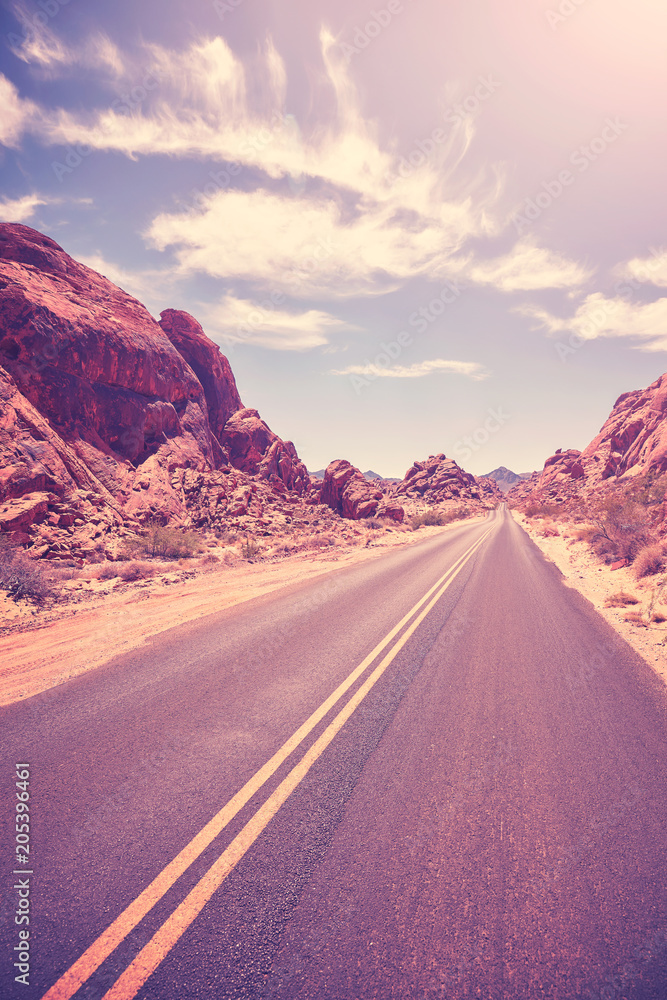 Retro toned deserted road, travel concept, Valley of Fire, Nevada, USA.