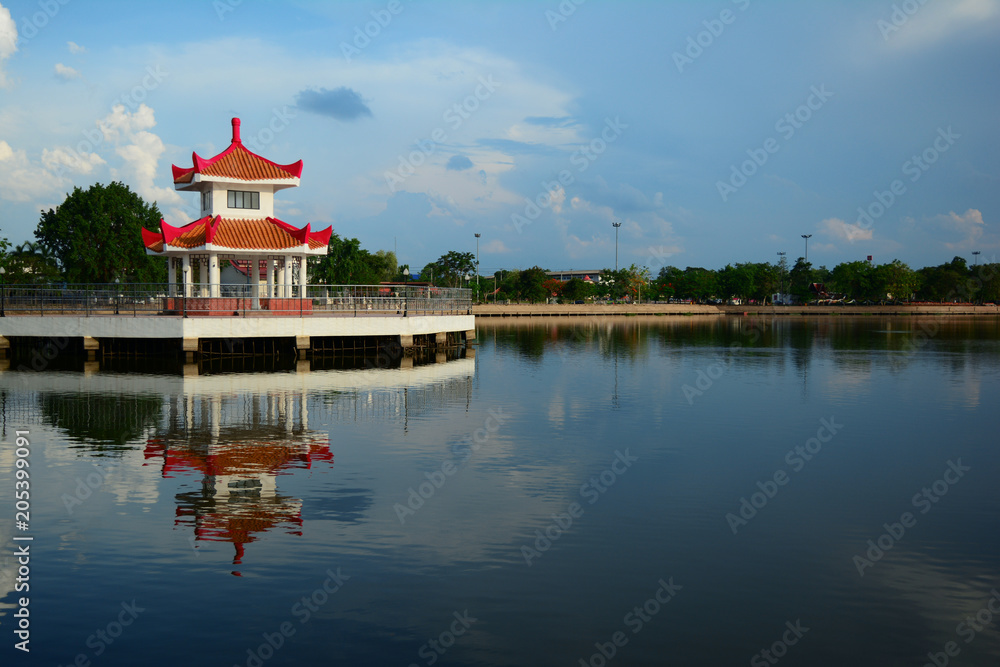 Obraz premium a chinese style pavilion in the water park city with blue sky and clouds