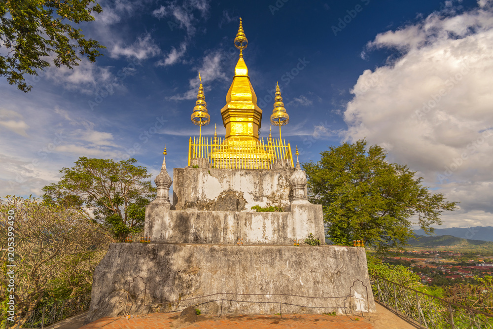 Naklejka premium Golden Wat That Chomsi temple Stupa on Mount Phousi in Luang Prabang, Laos.