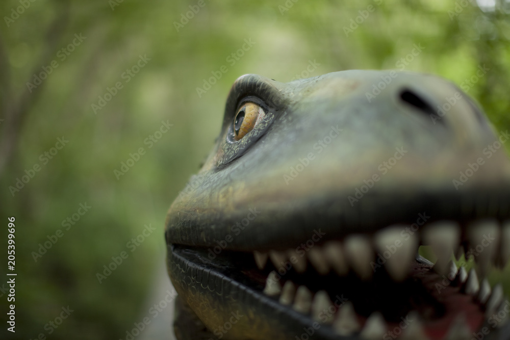 A dinosaur face close up smiling
