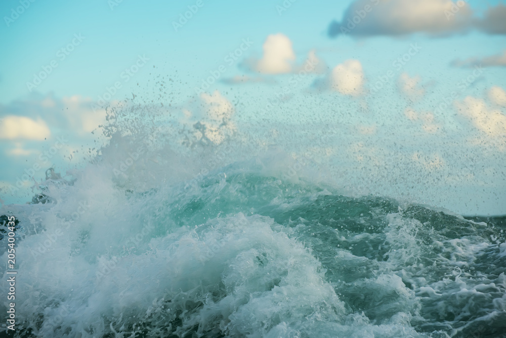 Wave, splashes in the ocean and the sky. Close view.
