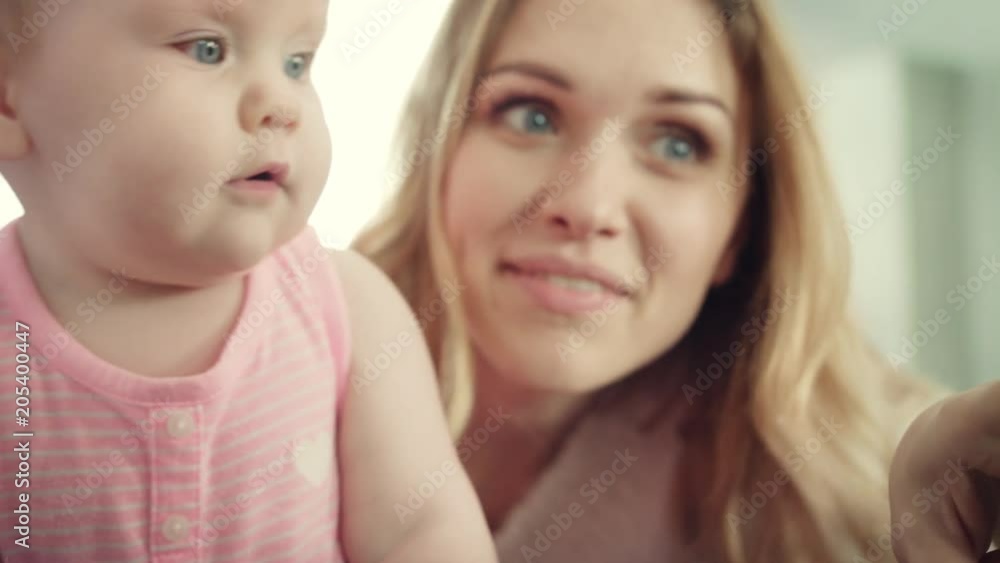 Happy mother with baby. Young mother showing something little child. Smiling woman embrace her kid. Happy mother embracing daughter. Cheerful woman enjoy parenting Happy mother with baby. Young mother showing something little child. Smiling woman embrace her kid. Happy mother embracing daughter. Cheerful woman enjoy parenting