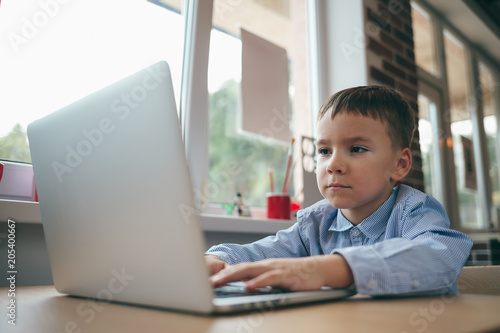 Boy typing on the laptop
