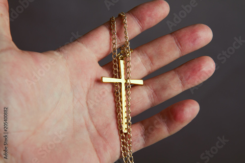 hand holds the cross