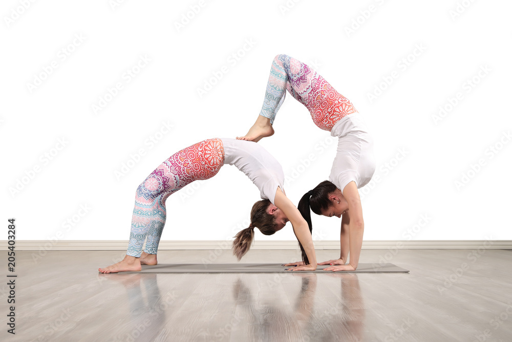 Fototapeta premium Young female acrobats in beautiful acrobatic poses