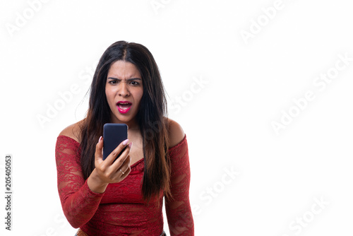 Angry woman yelling while looking at her phone