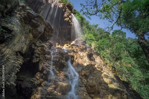 Tumpak Sewu Waterfall water soft  bright sunlight.