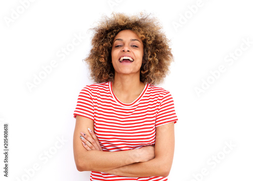 confident young black woman laughing against white background