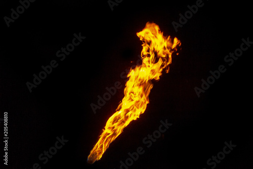 Fire  flame on a black background. Fire for advertising. An unusual game of bright red and yellow colors.