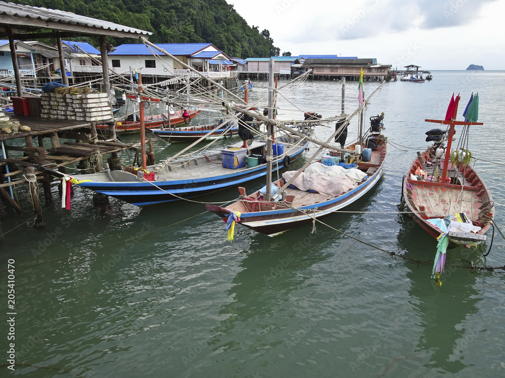 long-tailed boats in the parking lot in the sea