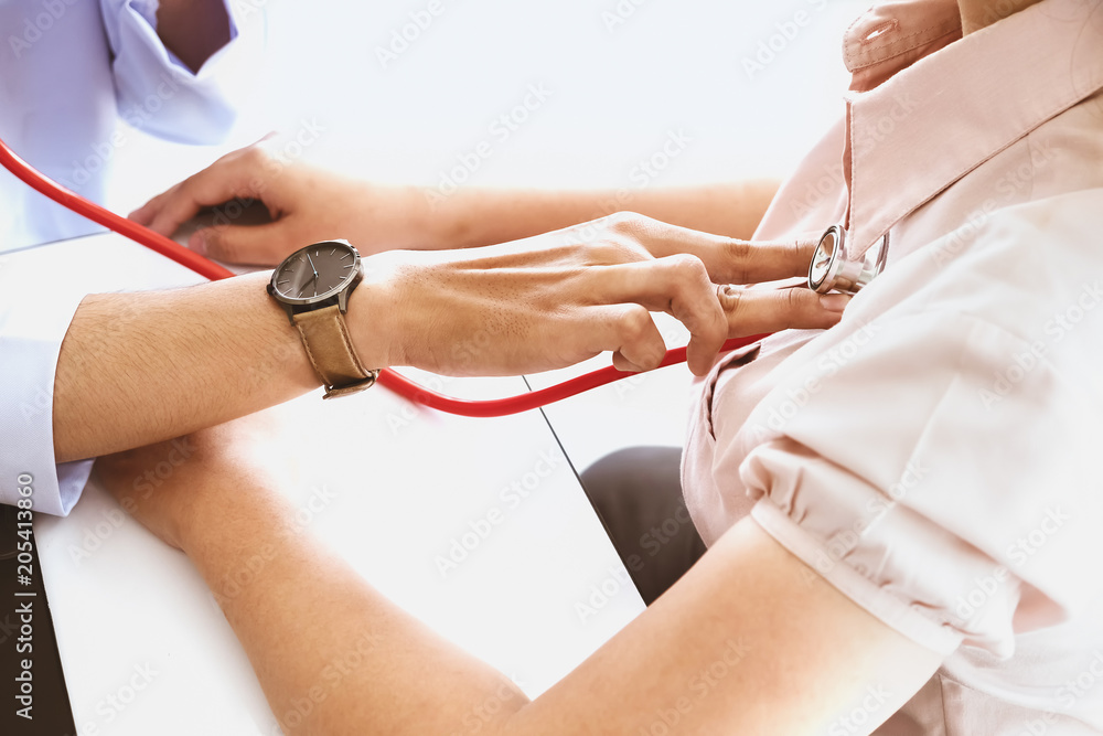 Fototapeta premium The concept of annual health check, the doctor is checking the rhythm of the heart.