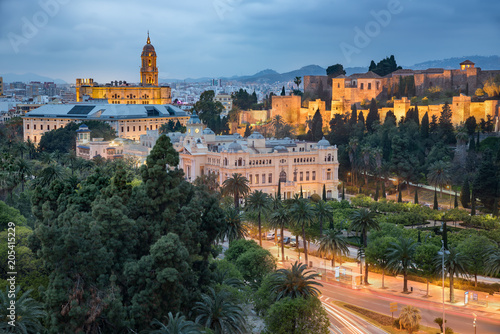 Malaga old town skyline with the city hall, cathedral and the Alcazaba citadel taken at the blue hour in a cloudy day, Andalucia, Spain photo