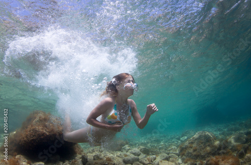 Beautifu girl jumps in the sea. © frantisek hojdysz