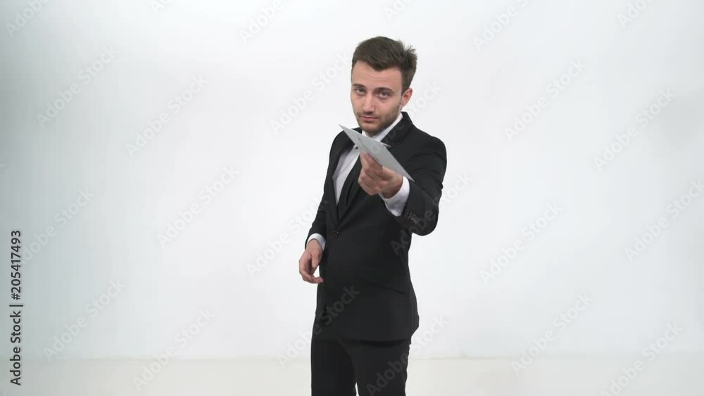 Businessman holds envelope on camera Businessman holds envelope on camera