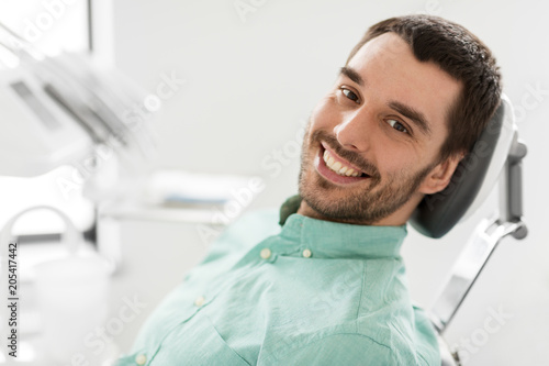 фотографія medicine, dentistry and healthcare concept - happy smiling male patient on chair