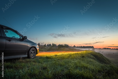 Car and light of headlights at sunset outdoors © kulkann