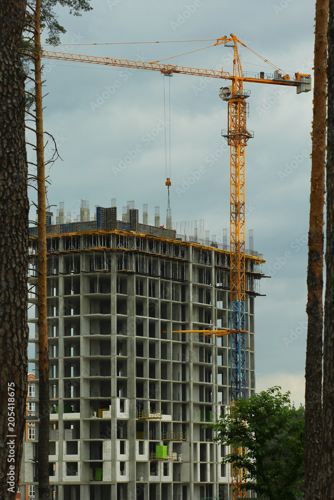 Deforestation problem concept. Multistory house being built in woodland Deforestation problem concept. Multistory house being built in woodland