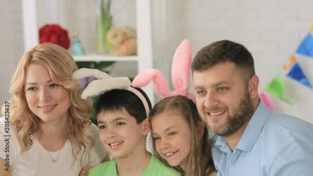 Portrait of happy family with two children wearing funny rabbit ears during Easter celebration Portrait of happy family with two children wearing funny rabbit ears during Easter celebration