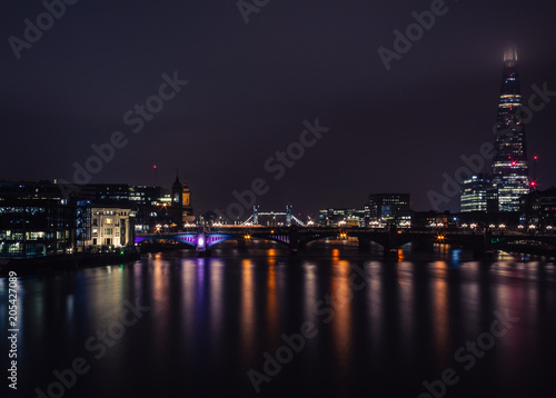 beautiful view of London at night, light reflections on river thames