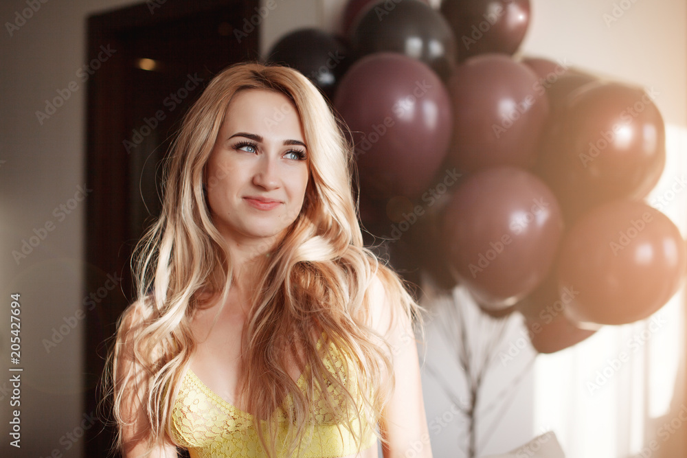 young happy blonde woman with baloons on background smiling close up young happy blonde woman with baloons on background smiling close up