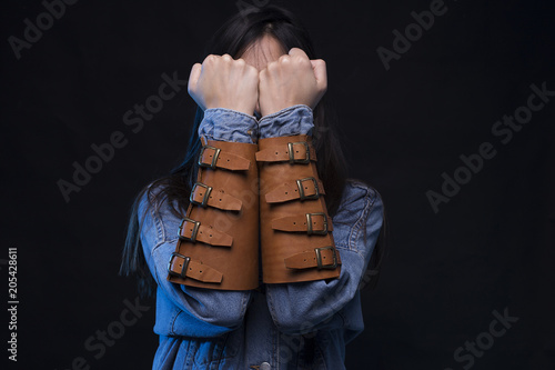 Young woman with raised fists guarding her face, power defense concept photo